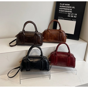 Detail showing vintage Boston bags in four colors with leather texture and straps