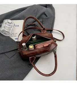 Macro view of spacious interior of dark brown leather handbag with daily essentials