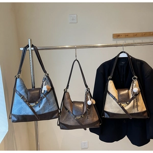 Detail showing vintage canvas and brown leather patchwork on multi-color tote bags
