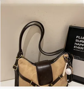 Detail view of khaki canvas and brown leather stitching on vintage retro tote bag