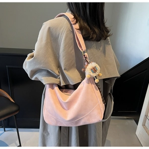 Pink large capacity crescent shoulder bag with wide strap and plush lion charm