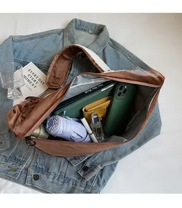 Interior view of brown plush dumpling bag showing capacity for umbrella and essentials