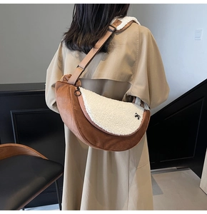 Detail of plush half-moon crossbody bag in brown suede and white faux shearling