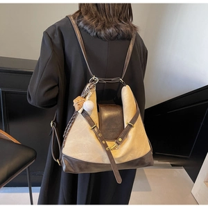 Detailed back view of a versatile beige canvas and brown leather tote backpack for women