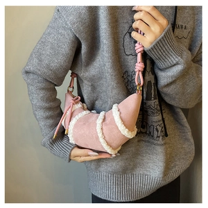 Detail der Halbmond-Umhängetasche aus rosa Wildlederimitat mit weißem Sherpa-Besatz