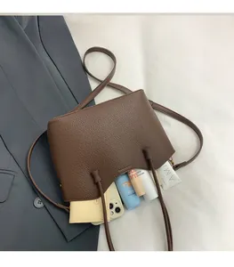 Capacité de rangement du sac fourre-tout en cuir marron avec motifs litchi et accessoires