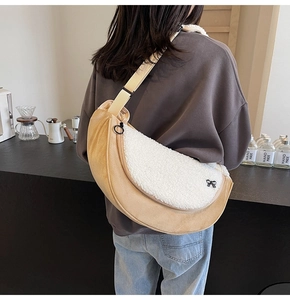 Detail view of yellow faux suede crossbody bag with fleece trim on model's back