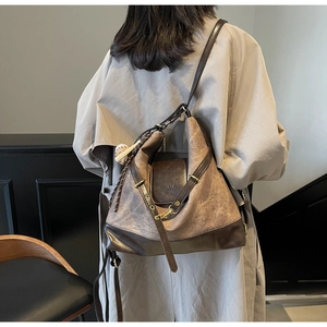 Close-up of a large vintage tote bag featuring a brown and khaki two-tone leather design