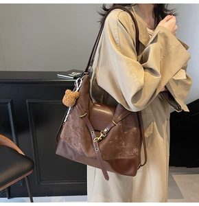 Deep brown faux suede tote bag with adjustable strap and teddy bear charm accessory