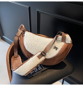 Brown faux suede and cream shearling crescent bag with bow detail and adjustable strap