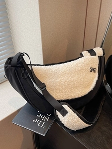 Black and white fuzzy crescent bag with plush lamb wool and metal bow detail