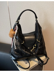 Versatile black faux leather tote bag with vintage texture and bear charm