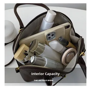 Detailed interior of vintage shell bag showing large capacity and herringbone lining