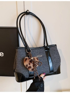 Grey fabric large shoulder bag with black patent leather handles and heart pendant