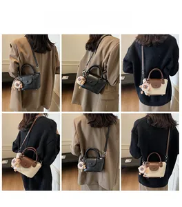 Detailed views of versatile handheld crossbody bags with a plush charm on the strap
