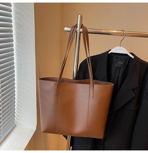 Vue latérale d'un grand sac cabas marron mat avec coutures décoratives sur support
