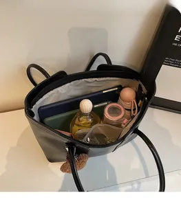 Internal view of large black tote bag showing spacious storage for essentials