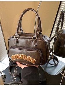 Retro dark brown Boston handbag with plush Holiday lettering and golden hardware
