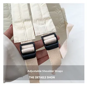 Detail of adjustable shoulder straps with black buckles on a quilted cream backpack