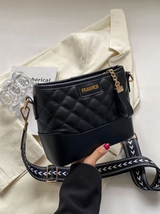 Black quilted crossbody bag with stylish geometric woven strap and gold chain detail