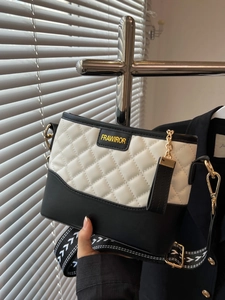 Quilted black and white crossbody bag with gold chain and woven shoulder strap