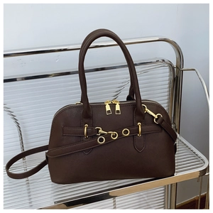 Close-up of vintage shell bag with gold hardware and fine stitching on leather