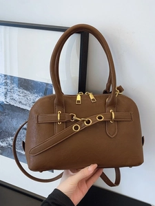 Retro brown leather Boston handbag with gold hardware and adjustable strap on white background