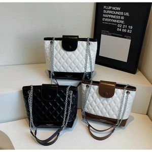 Detailed comparison of quilted leather bucket bags in monochrome and contrast colors