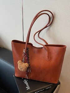 Vintage brown large capacity tote bag with plush bear charm and woven cord detail