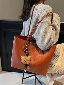 Vintage caramel brown large tote bag with bear charm and long straps in crossbody style