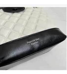 Close-up of quilted leather tote bag with black and white contrast and fashion text
