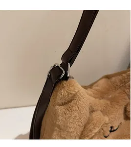 Detail of soft brown faux fur bag with adjustable PU leather strap and silver metal buckle