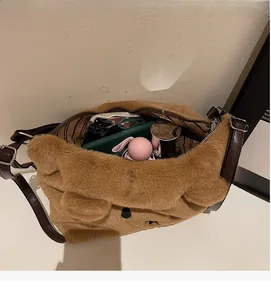 Detail view of large interior capacity and striped lining of brown plush teddy bag