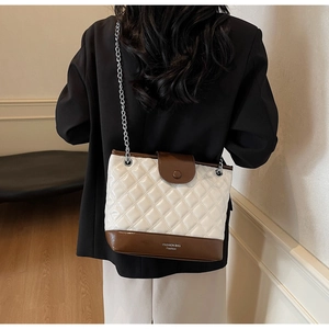 Detailed back view of a quilted contrast bucket bag showing the fashion bag logo and strap