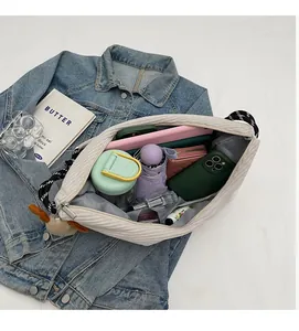 Detail view of large corduroy crossbody bag interior showing spacious storage capacity