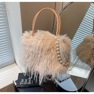 Close-up of leopard print bucket bag featuring plush faux fur and pearl handle detail