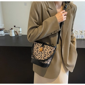 Detail der Leoparden-Beuteltasche mit goldenem Drehverschluss und Lederriemen