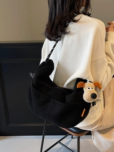 Large black corduroy crescent crossbody bag with thick rope strap and cute dog pendant