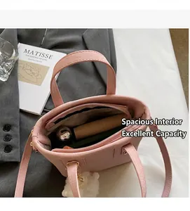 Internal view of pink suede bucket bag showing large capacity and inner zipper pocket