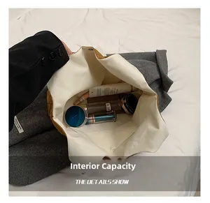 Detail view of large capacity tote bag interior with multiple cosmetics and pocket