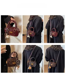 Multiple views of a mini vintage Boston bag with gold hardware and baseball charm