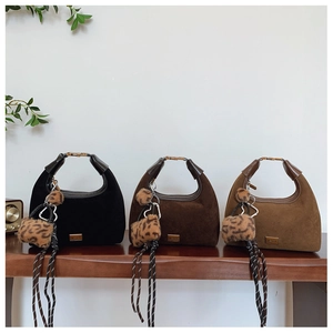 Detailed trio of matte crescent bags with leopard pom-poms and braided rope accents