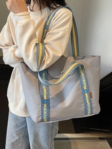 Grey large capacity nylon tote bag with colorful woven shoulder strap for daily use