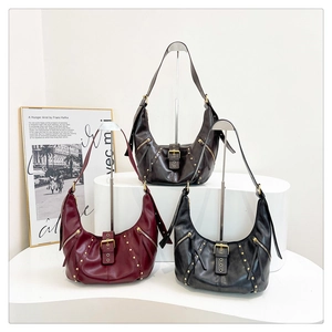 Detailed view of vintage crescent hobo bags in dark brown, wine red and black with rivets