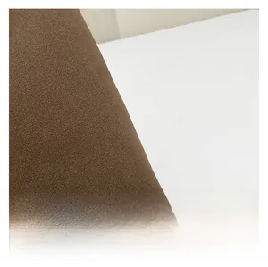 Detailed macro view of high-quality dark brown textured suede fabric of the tote bag