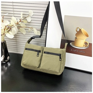 Olive green utility nylon crossbody bag featuring multiple pockets and durable straps