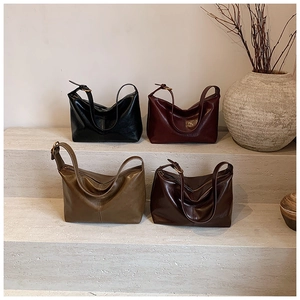 Detail showing minimalist leather hobo bags in black, burgundy, olive, and brown colors