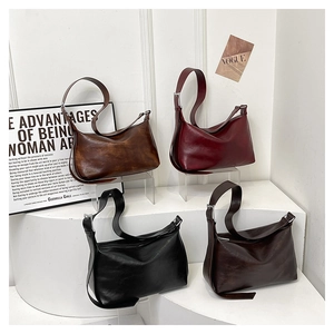 Detailed view of vintage crescent shoulder bags in multiple retro color options