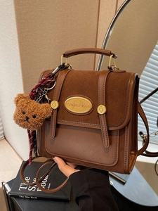 Retro brown suede and leather satchel backpack with gold plaque and bear charm