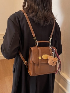 Retro brown leather backpack for women with metal buckle and plush bear pendant